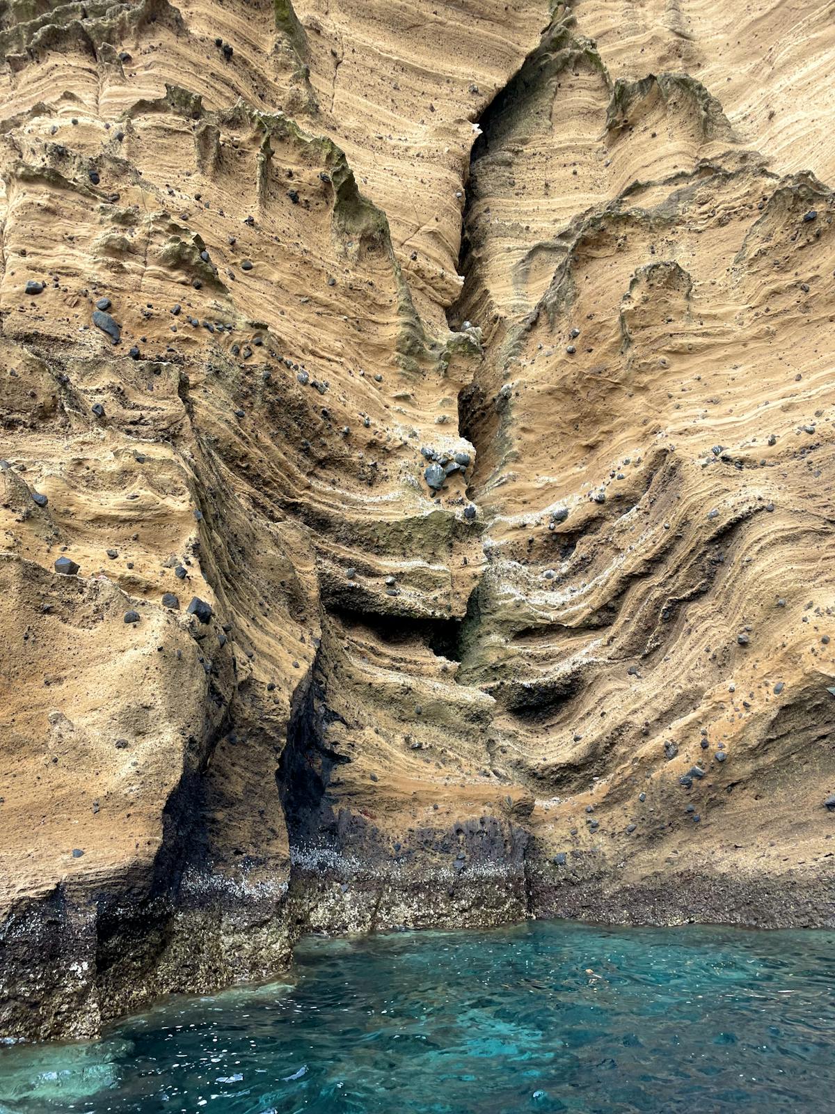Hidden beach cove in Corfu with turquoise water and dramatic cliffs